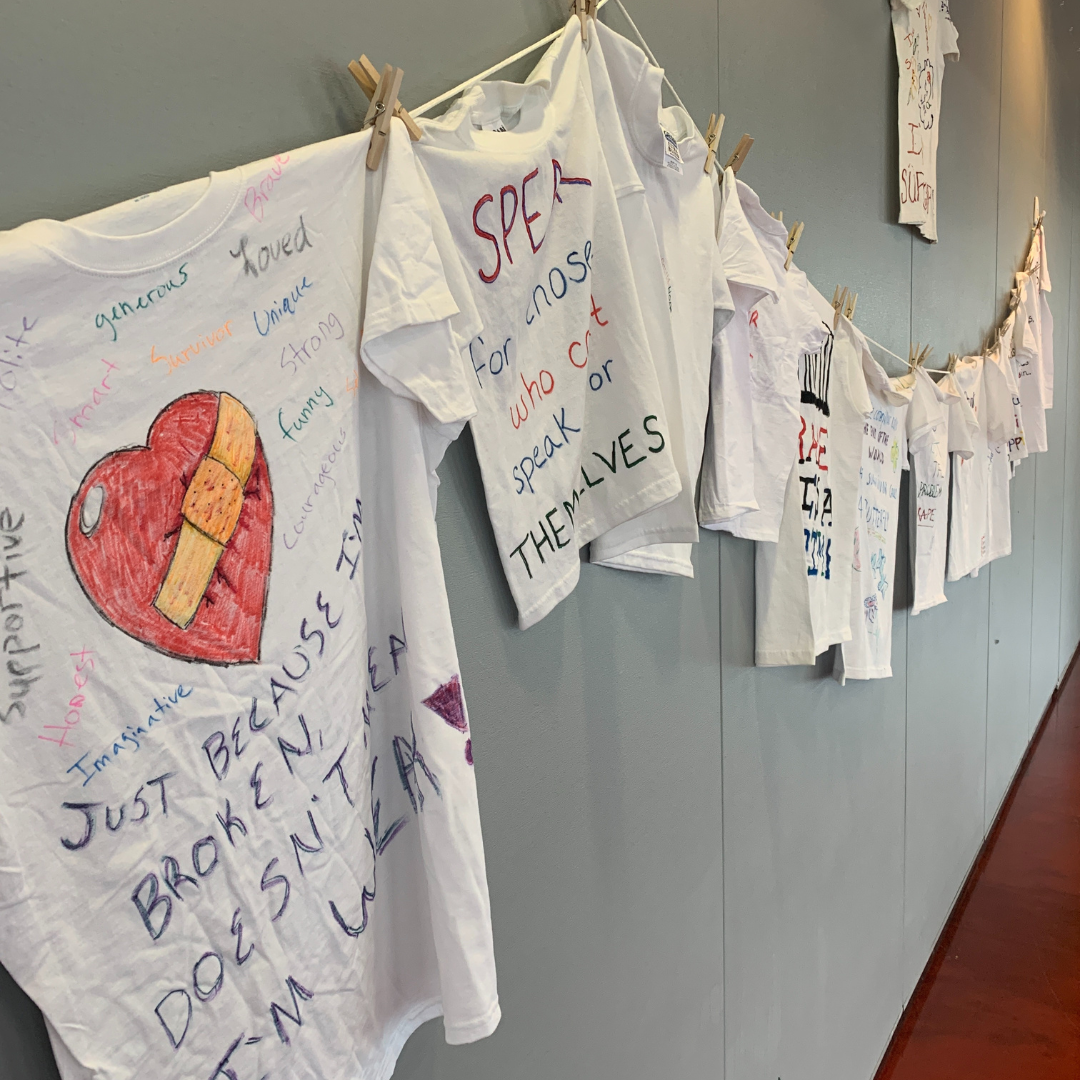 Clothesline Project shirts hanging on a line