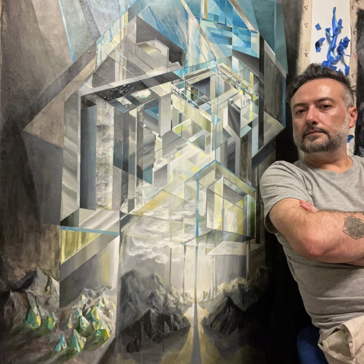Artist stands next to one of his paintings